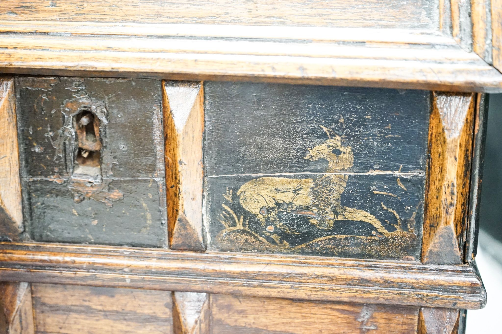 An unusual early 18th century Continental painted chestnut, oak and walnut table-top trunk with concealed drawers 38cm